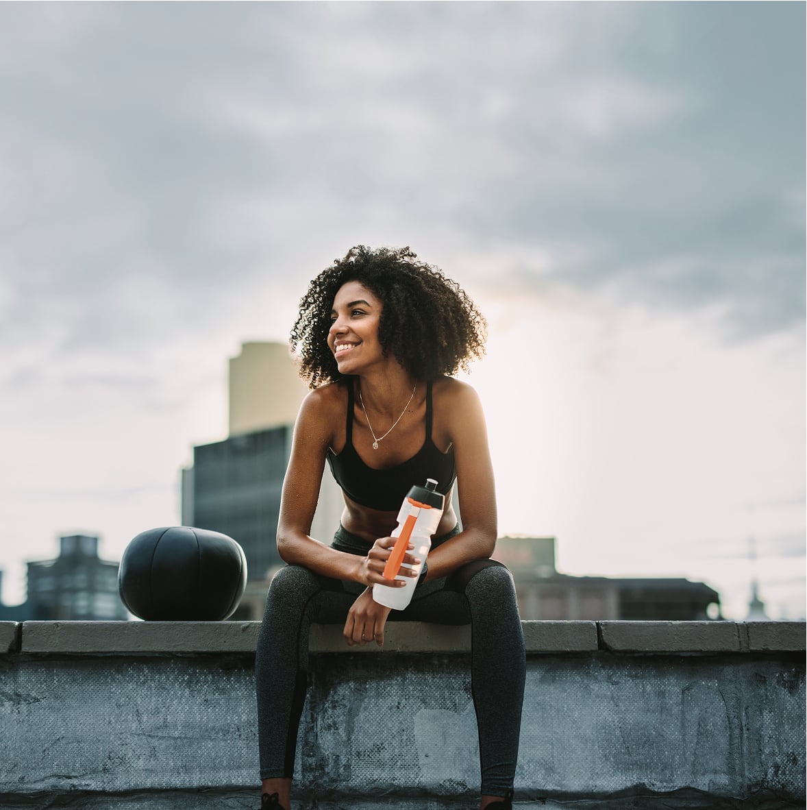 Woman in athleisure wear with water bottle